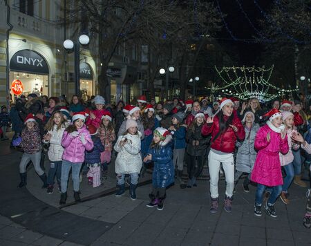 Burgas, Bulgaria - December 23, 2017: Happy kids with families on flashmob days before christmas and new year's dayのeditorial素材