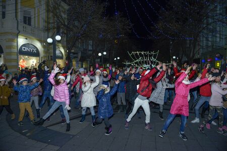 Burgas, Bulgaria - December 23, 2017: Happy kids with families on flashmob days before christmas and new year's dayのeditorial素材
