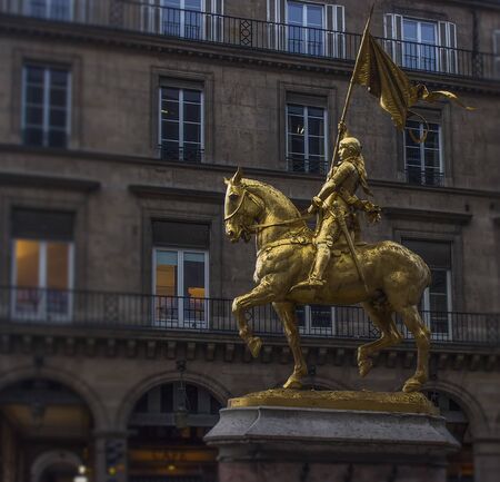 Golden statue of Joan of Arc on horse with flag holding upの写真素材