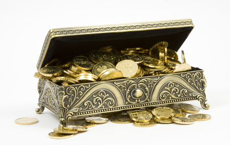gold casket and gold coins on a white backgroundの写真素材