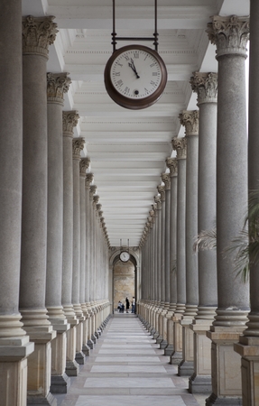 Old clock, and stone columns in Karlovy Vary, Czech Republic