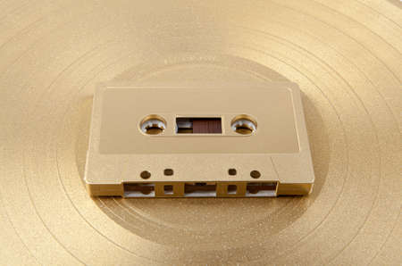 A golden cassette tape on the white backgroundの写真素材