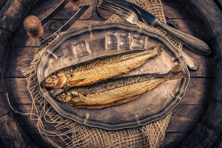 Smoked fish on a wooden background. top view. Toned.の写真素材