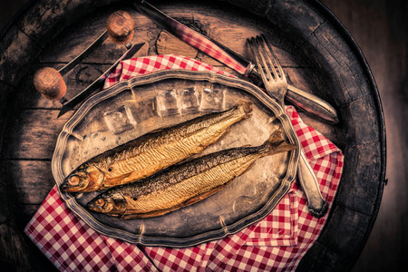Smoked fish in a traditional way on a rustic background