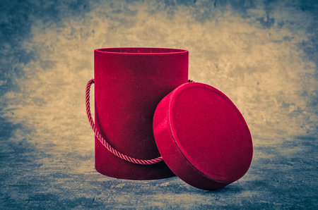 Red gift box on grunge background. Shallow depth of field.