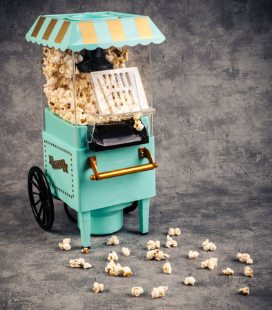 Popcorn cart with popcorn on gray background. toned image.の写真素材