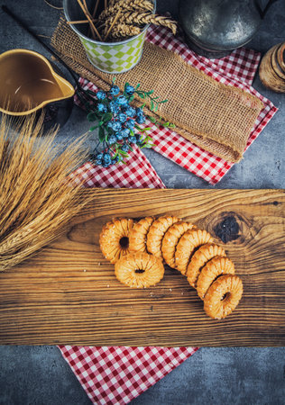 Biscuits and wheat on a wooden board. Toned.