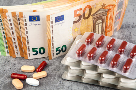 Pills and euro banknotes on gray background, close-upの写真素材
