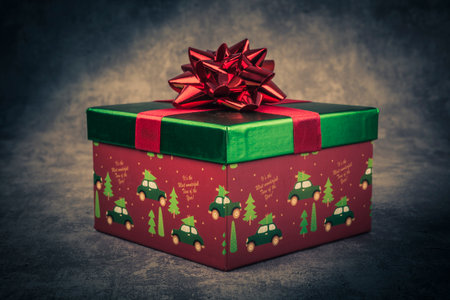 Gift box with red bow on dark background. Toned.の写真素材