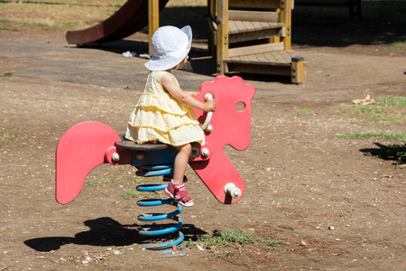 Baby girl on the playgroundの写真素材