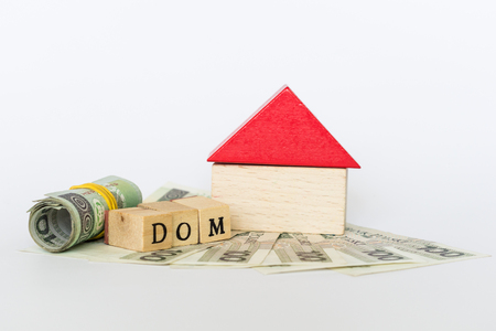 Wooden model of a house standing on polish money, "dom" means "house"の写真素材