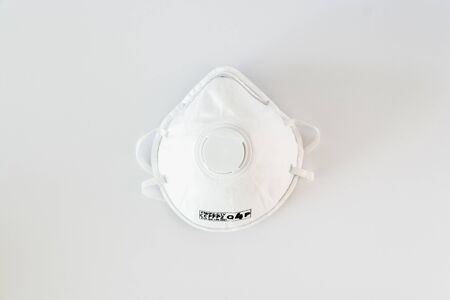 White ffp2 protective mask isolated. Coronavirus and pollution protection, studio photo conceptの写真素材