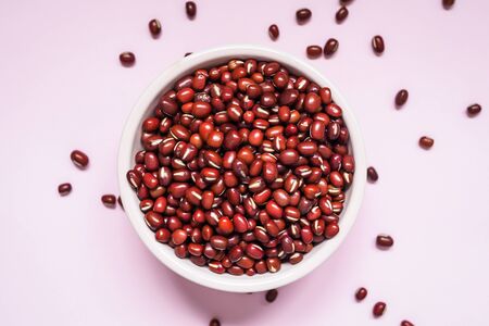 Fresh uncooked adzuki beans or red mung beans in a bowlの写真素材