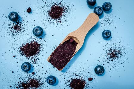 Dried blueberry powder on a wooden scoope, vegan foodの写真素材
