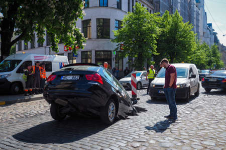 Riga/Latvia - June 5, 2020: Car fell into sinkhole which had opened after street surfacing caved in on Gertrudes Street during hydraulic testsのeditorial素材