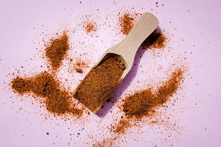 Dried tomato powder on a wooden scoope, vegan food