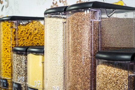 Bulk dry food dispensers at zero waste shop, defocusedの写真素材