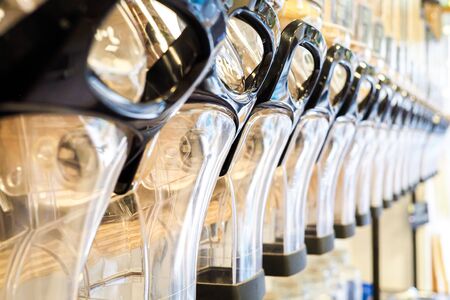 Bulk dry food dispensers at zero waste shop, defocusedの写真素材