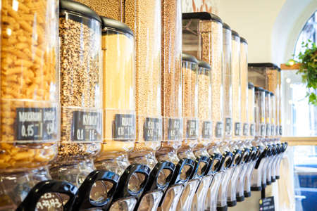 Bulk dry food dispensers at zero waste shop, defocusedの写真素材