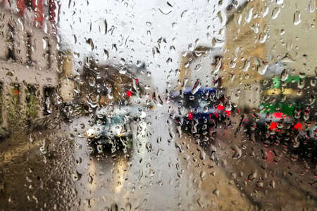 Close up of raindrops on wet glass window of a tramの写真素材
