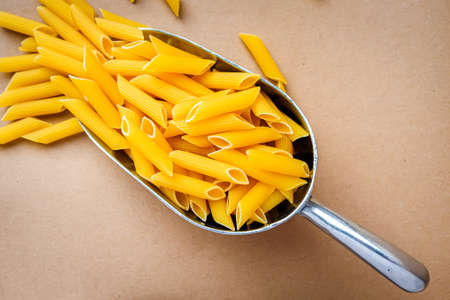 Penne pasta on a food scoop in a zero waste shopの写真素材