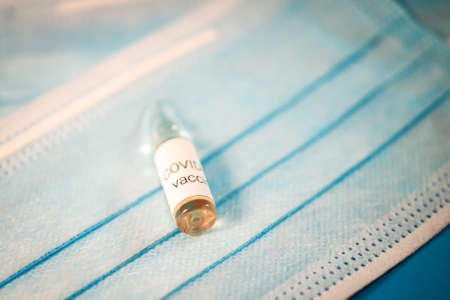 Glass ampoule with vaccine COVID-19, Vaccination against coronavirus helps strengthen immunity. Selective focusの写真素材