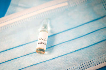 Glass ampoule with vaccine COVID-19, Vaccination against coronavirus helps strengthen immunity. Selective focusの写真素材