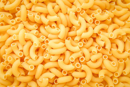 Uncooked pasta cornetti background, texture