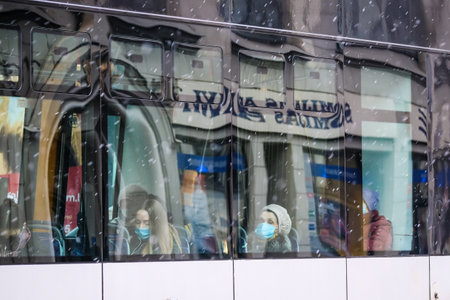 Lined up public electric scooters for rent in the city. Electric scooter transportation. Electric scooters steering wheels.のeditorial素材