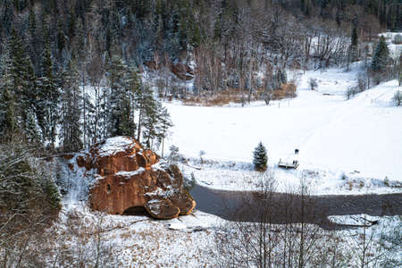 Zvartas red rock and river Amata at city Cesis in Latvia. Winter photoの写真素材