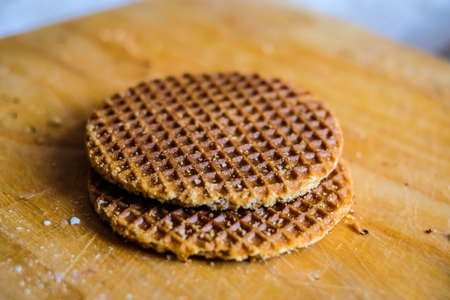 Traditional dutch Stroopwafels, honey wafers, on a wooden board. Selective focusの写真素材