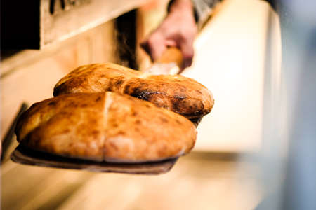Fresh healthy steaming pita bread just from the oven in the bakery. Selective focusの写真素材