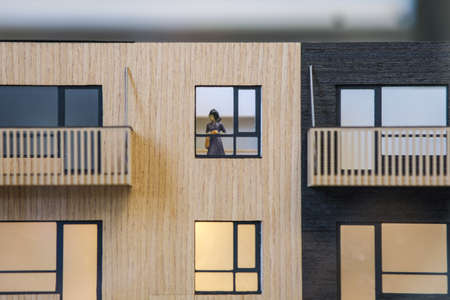 Real estate concept. Female figure in an apartment house model. Real estate development. Defocusedの写真素材