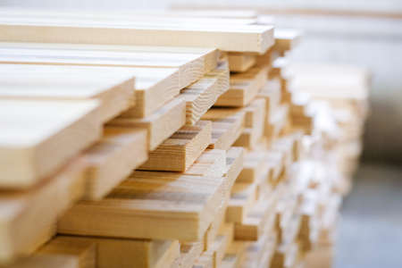A large pile of wooden boards stored in a sawmill. Selective focusの写真素材