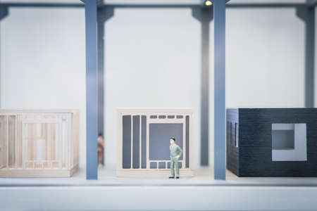 Real estate concept. Human figure in an apartment house model. Real estate development. Defocusedの写真素材