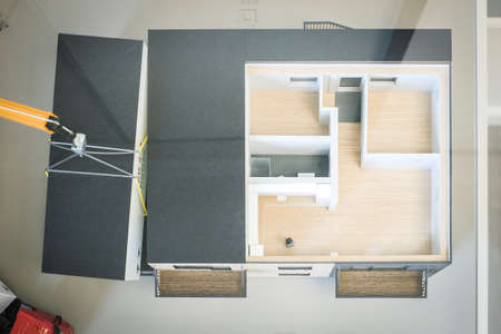 Real estate concept. Human figure in an apartment house model. Real estate development. Defocusedの写真素材
