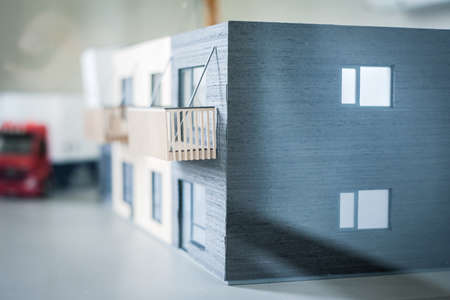 Real estate concept. Human figure in an apartment house model. Real estate development. Defocusedの写真素材
