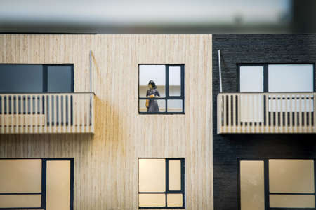 Real estate concept. Human figure in an apartment house model. Real estate development. Defocusedの写真素材