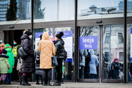 Riga, Latvia - March 8, 2022: Ukrainian refugees that fleeing from the war in Ukraine gather at a refugee reception center in Riga, Latvia. Selective focusのeditorial素材