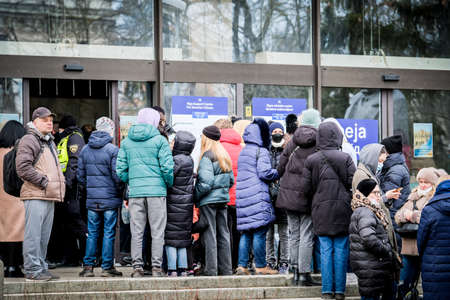 Riga, Latvia - March 8, 2022: Ukrainian refugees that fleeing from the war in Ukraine gather at a refugee reception center in Riga, Latvia. Selective focusのeditorial素材