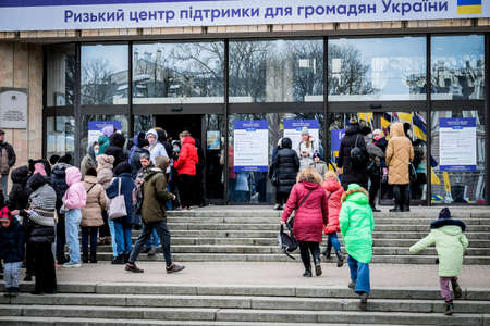 Riga, Latvia - March 8, 2022: Ukrainian refugees that fleeing from the war in Ukraine gather at a...