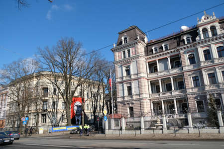 Riga, Latvia - March 9, 2022: A poster of Russian President Vladimir Putin appeared on the building of the Museum of Medical History. The museum is located directly in front of the Russian embassy.のeditorial素材