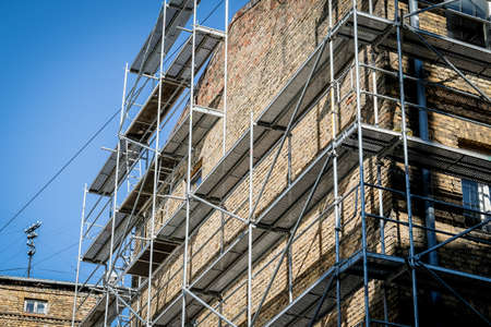Reconstruction of an old brick house. Scaffolding for construction, construction site. Selective focusの写真素材