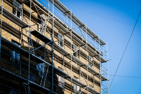 Reconstruction of an old brick house. Scaffolding for construction, construction site. Selective...
