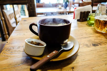 Hot Czech garlic soup in a pub on the table. Defocusedの写真素材