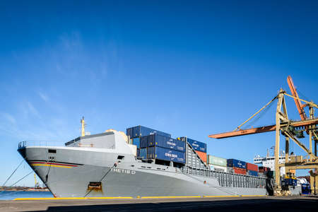 Riga, Latvia - April 20, 2022: Baltic Container Terminal in Freeport of Riga. Riga harbour, Latvia. Container ships in a port. Defocusedのeditorial素材