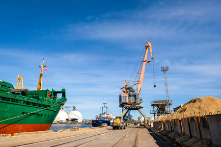 Riga, Latvia - April 20, 2022: Baltic Container Terminal in Freeport of Riga. Riga harbour, Latvia. Container ships in a port. Defocusedのeditorial素材