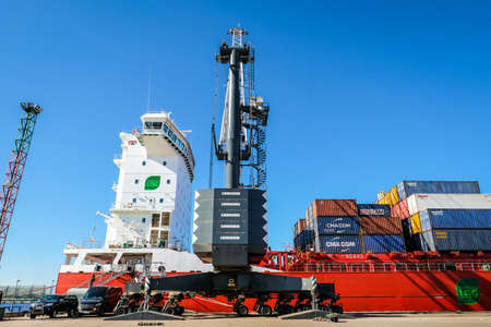 Riga, Latvia - April 20, 2022: Baltic Container Terminal in Freeport of Riga. Riga harbour, Latvia. Container ships in a port. Defocusedのeditorial素材