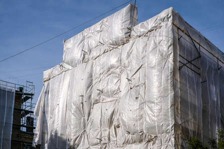 Reconstruction of an old brick house. Scaffolding for construction, construction site. Selective focusの写真素材