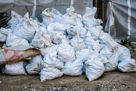 Construction waste. Garbage in the bags after the reconstruction of the apartment. Illegal dumping. Selective focus.の写真素材